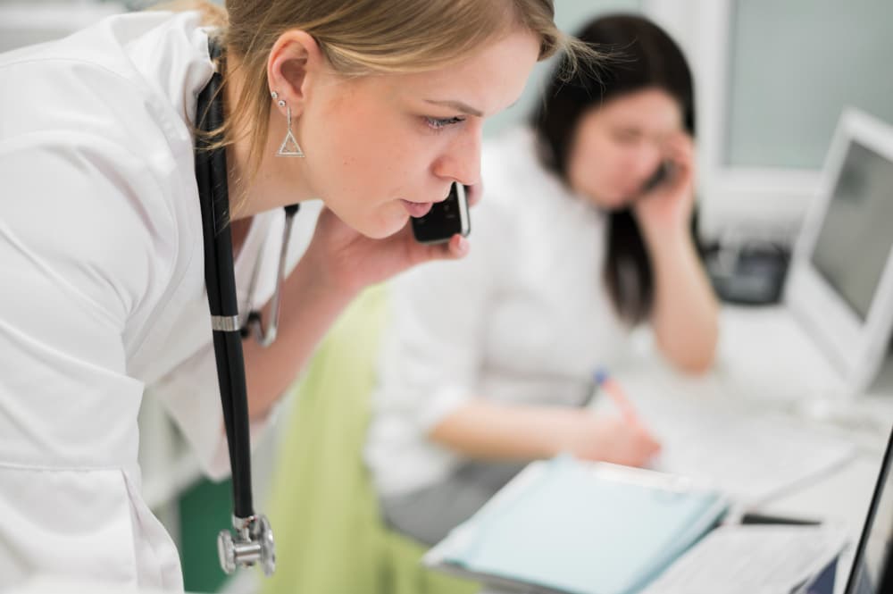 Healthcare professional using digital interface with medical icons