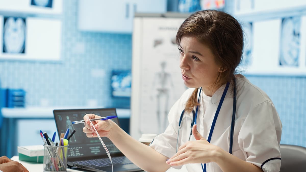 Healthcare professional using digital interface with medical icons